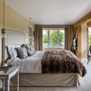 bedroom with curtains and faux fur throw blanket