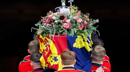 Queen ELizabeth II's coffin with the royal standard flag and bouquet