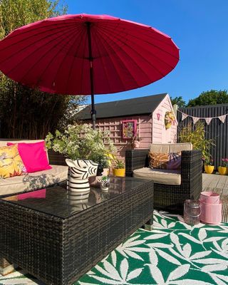 Outdoor patio with rug and pink umbrella