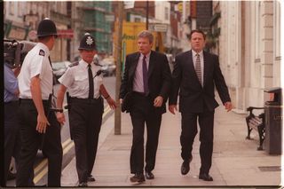 Sion Jenkins arriving to court with two police officers