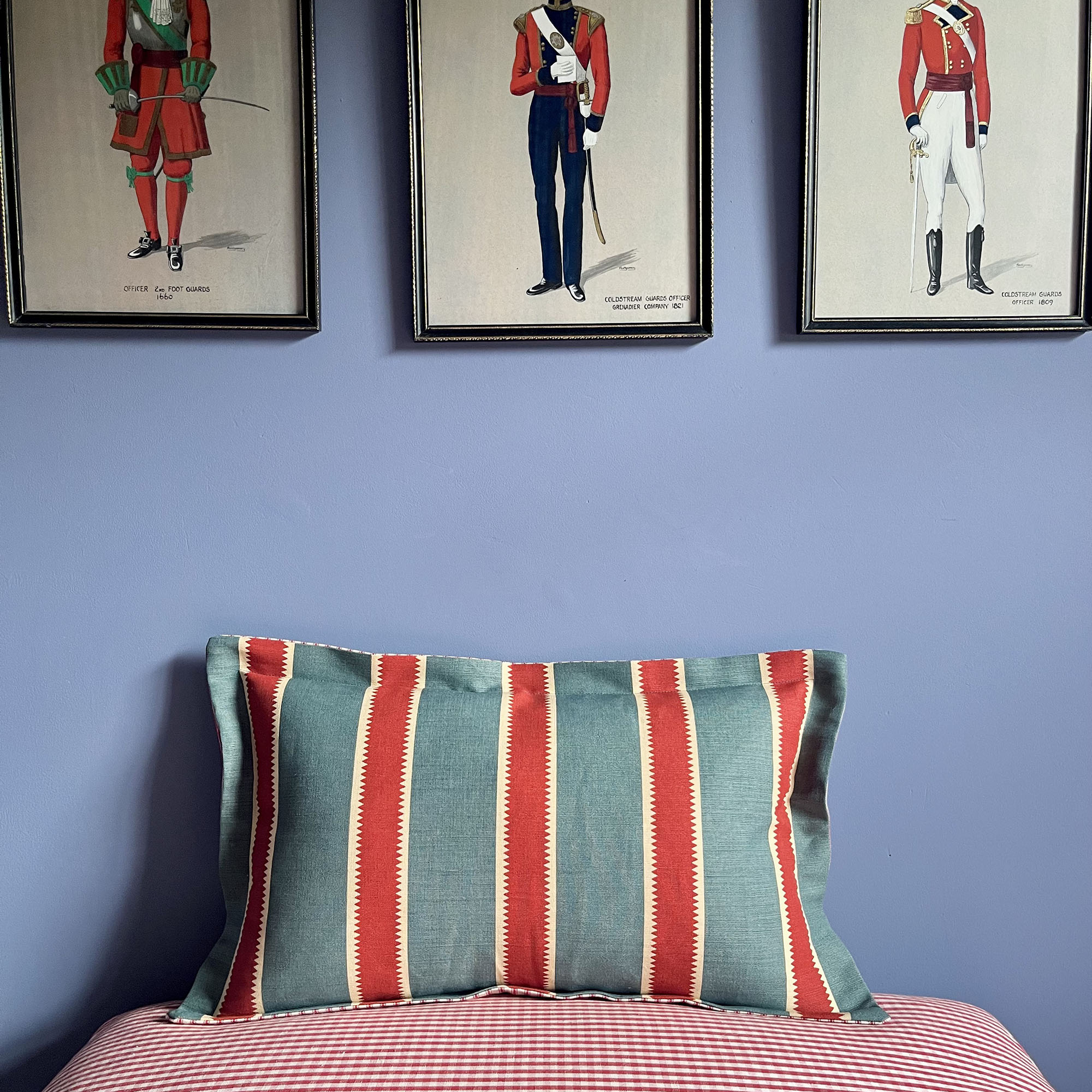 striped cushion in front of a blue wall