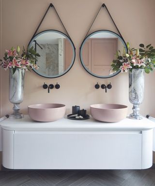 Double vanity bathroom unit with round mirrors over them