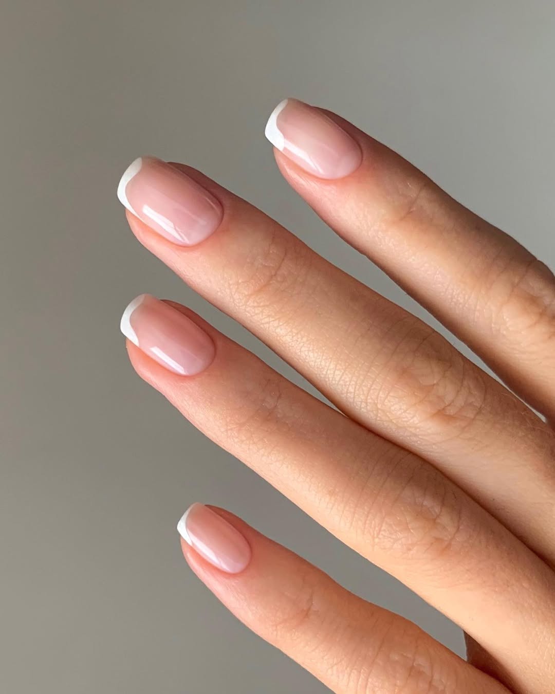 A french manicure with wavy white tips by Georgia Rae
