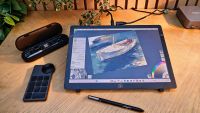 A drawing tablet on a wooden desk