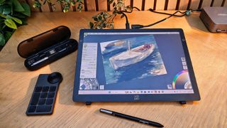 A drawing tablet on a wooden desk