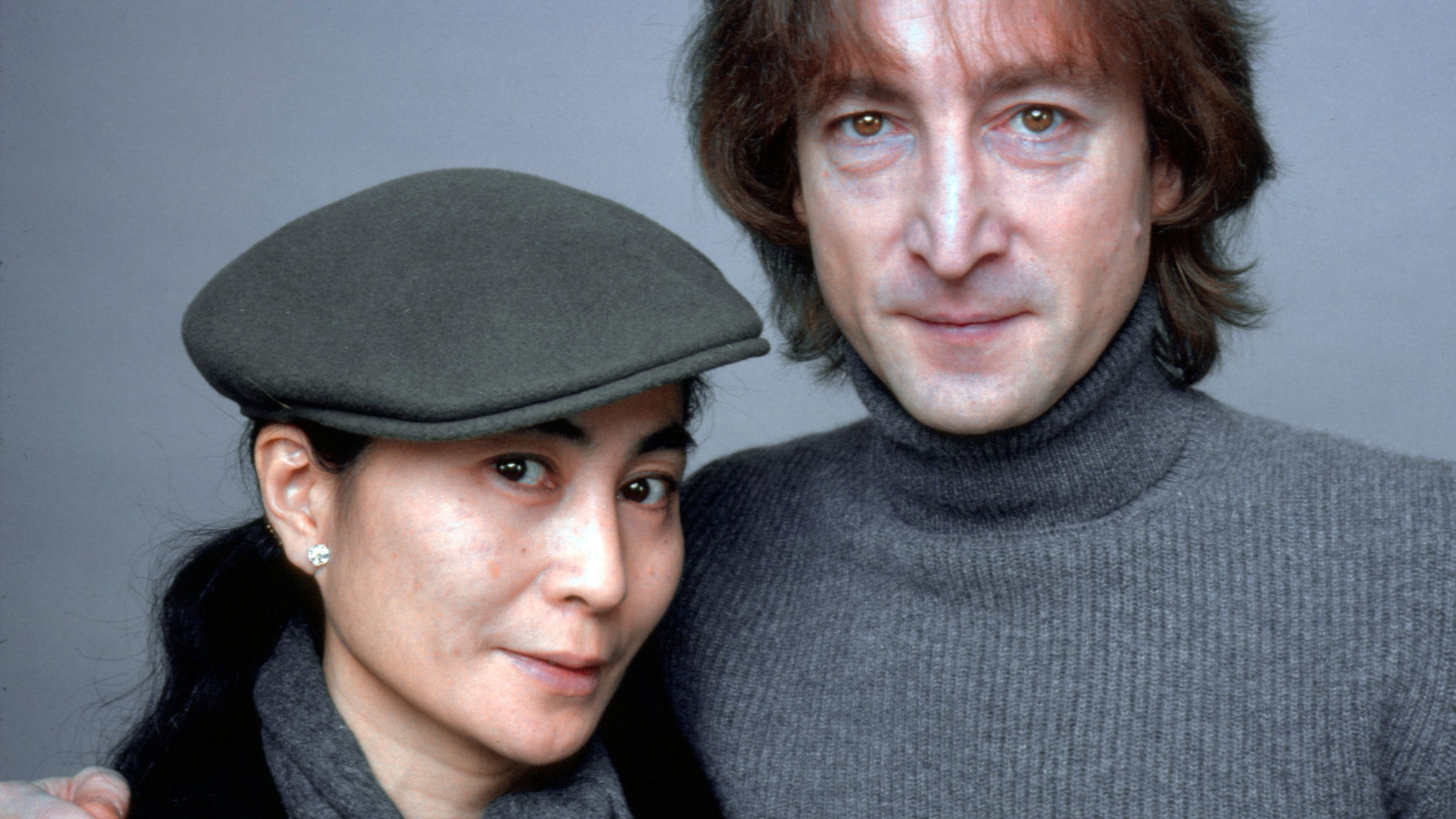 john lennon and yoko ono on a gray background