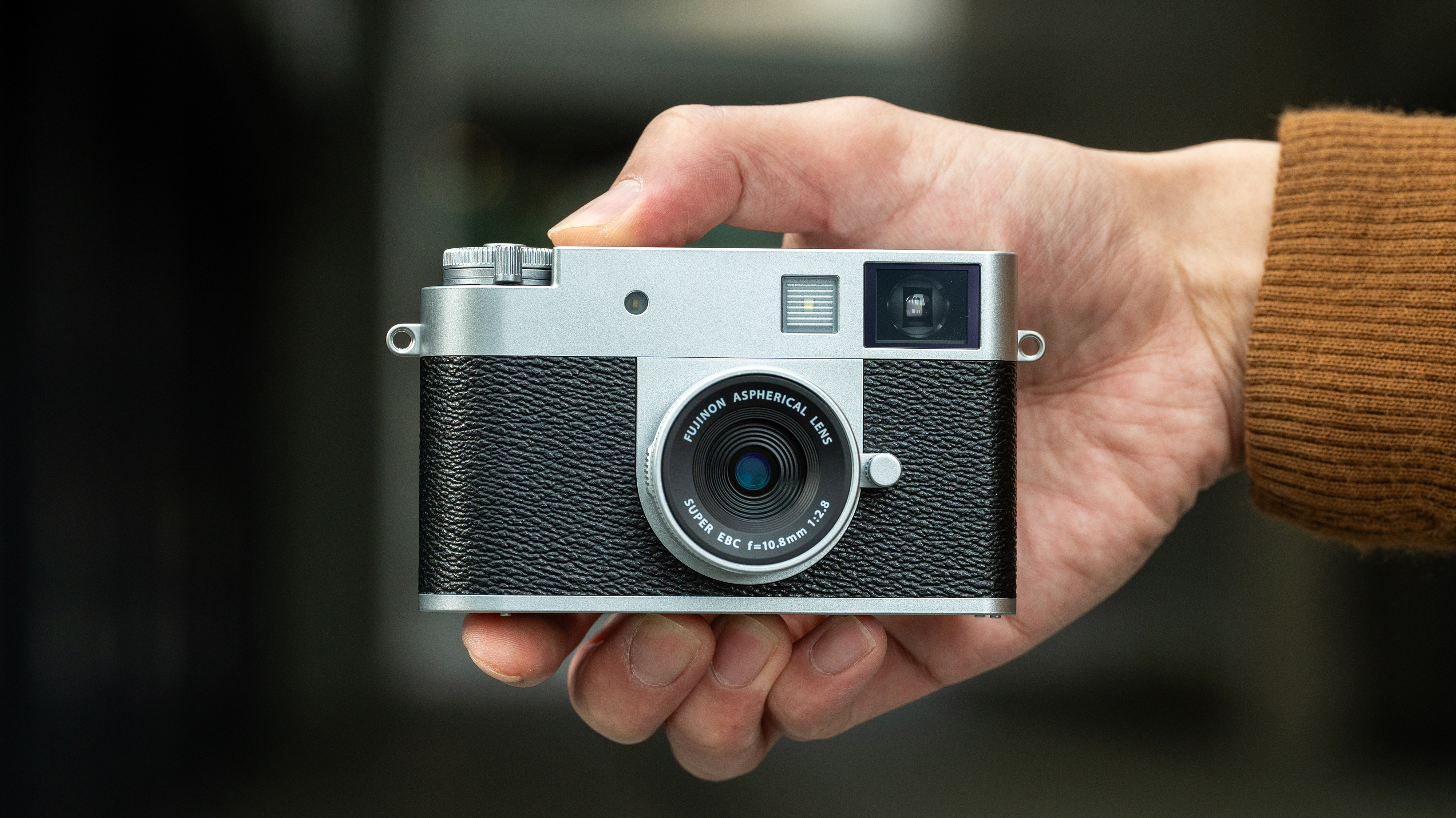 The Fujifilm X Half retro compact camera in a person&#039;s hands
