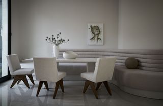 breakfast banquette with curved seating and neutral color palette