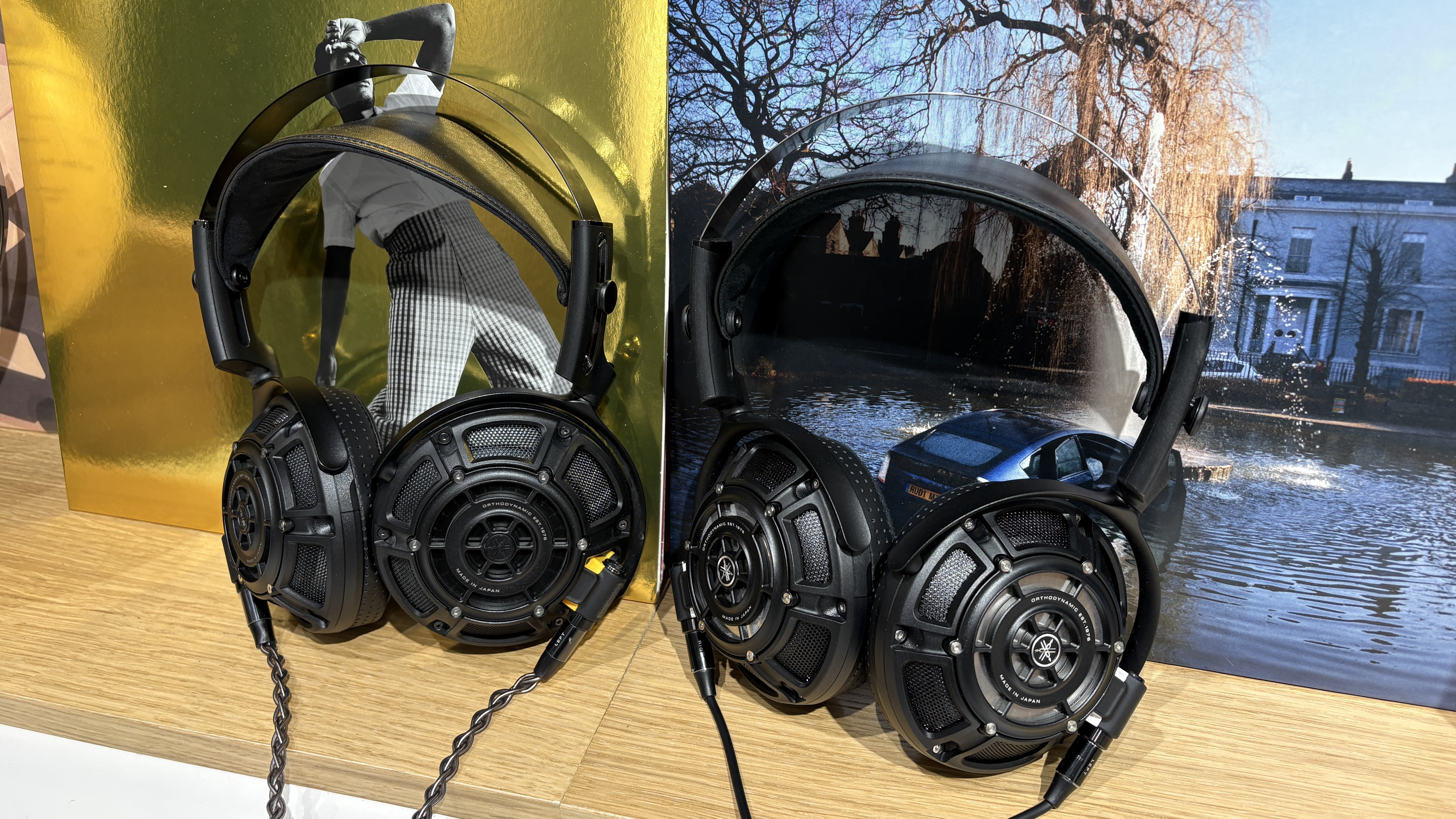 Yamaha YH-5000SE and YH-4000 headphones side-by-side on a desk with vinyl records in background