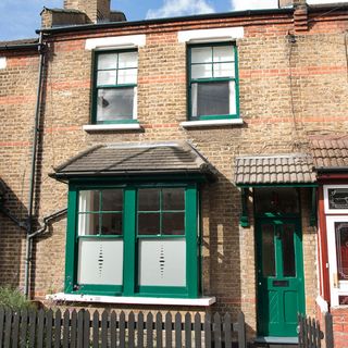 exterior of house with brick walls and green door