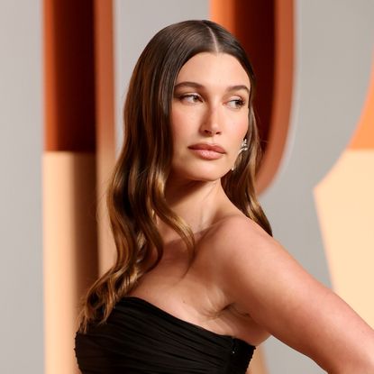 Hailey Bieber wears a strapless black gown with a sheer skirt to the Oscars Vanity Fair party