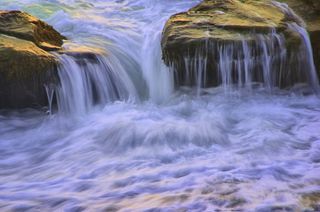 Waves cascading over rocks.