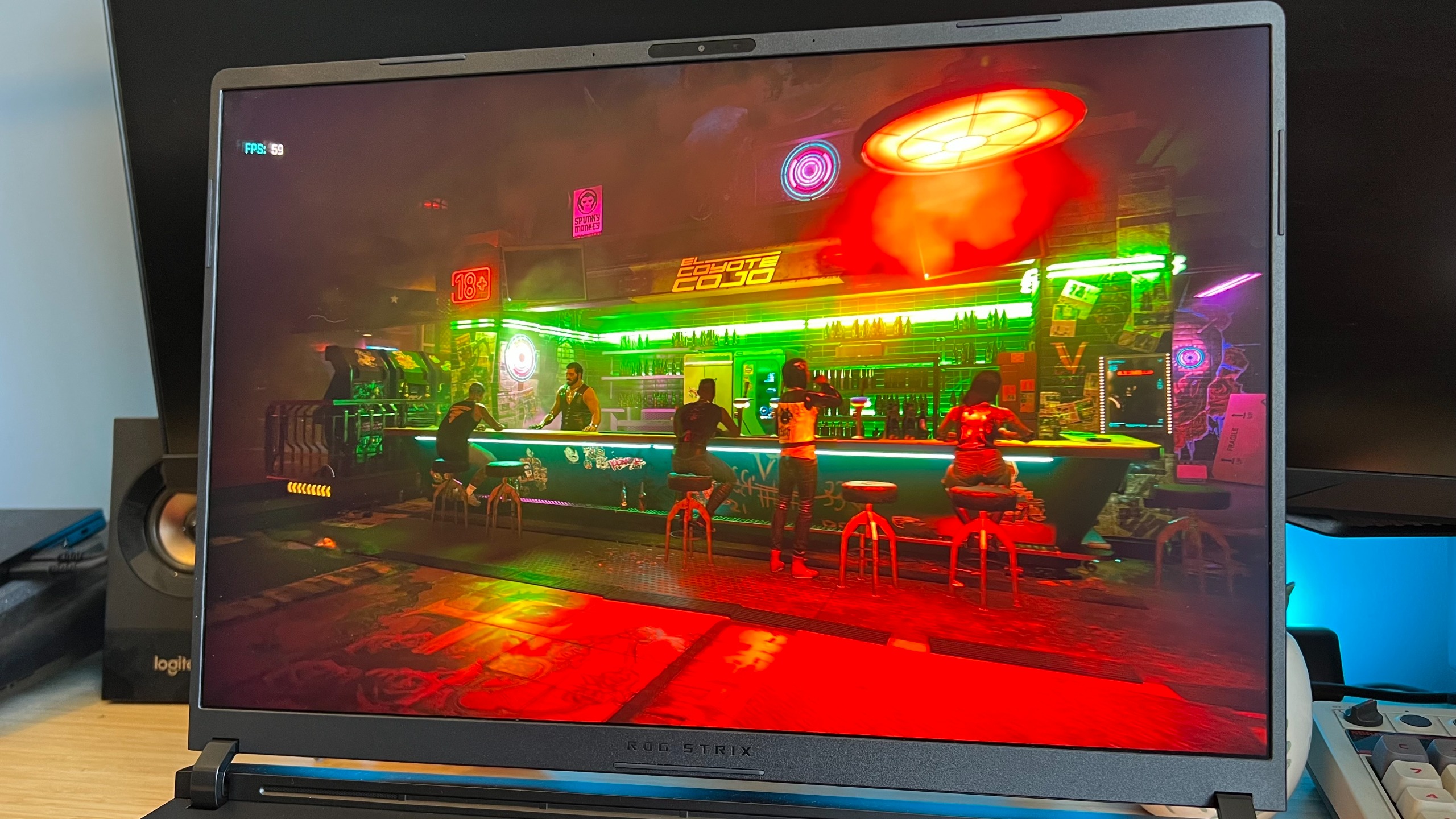 Cyberpunk 2077 bar scene showing on Asus ROG Strix Scar 18 gaming laptop display