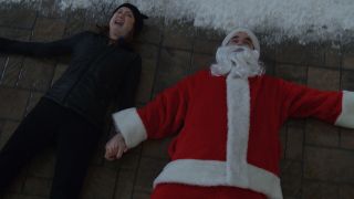 Ellie Kemper and Rob Delaney sprawled on the ground in pain Home Sweet Home Alone.