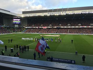 The teams line up for kick-off at Ibrox