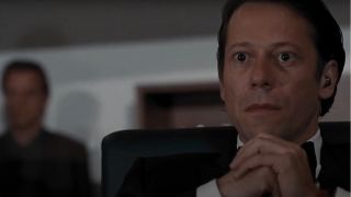 Mathieu Amalric sits listening intently in Quantium of Solace.