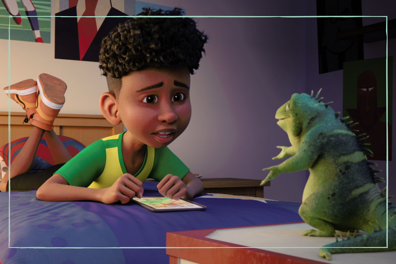 A boy talking to a lizard in the movie Leo 