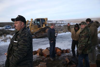 Armed protesters at the Malheur National Wildlife Refute are tearing down fences