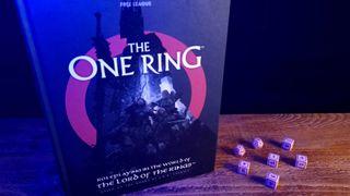 The One Ring Core Rulebook and dice on a wooden table, against a dark background