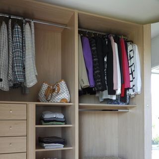 room with white wall and cloths bag in wardrobes