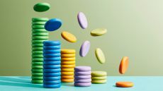 Multicoloured discs representing coins falling onto stacks