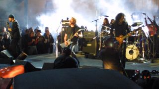 Metallica performing onstage in 2000