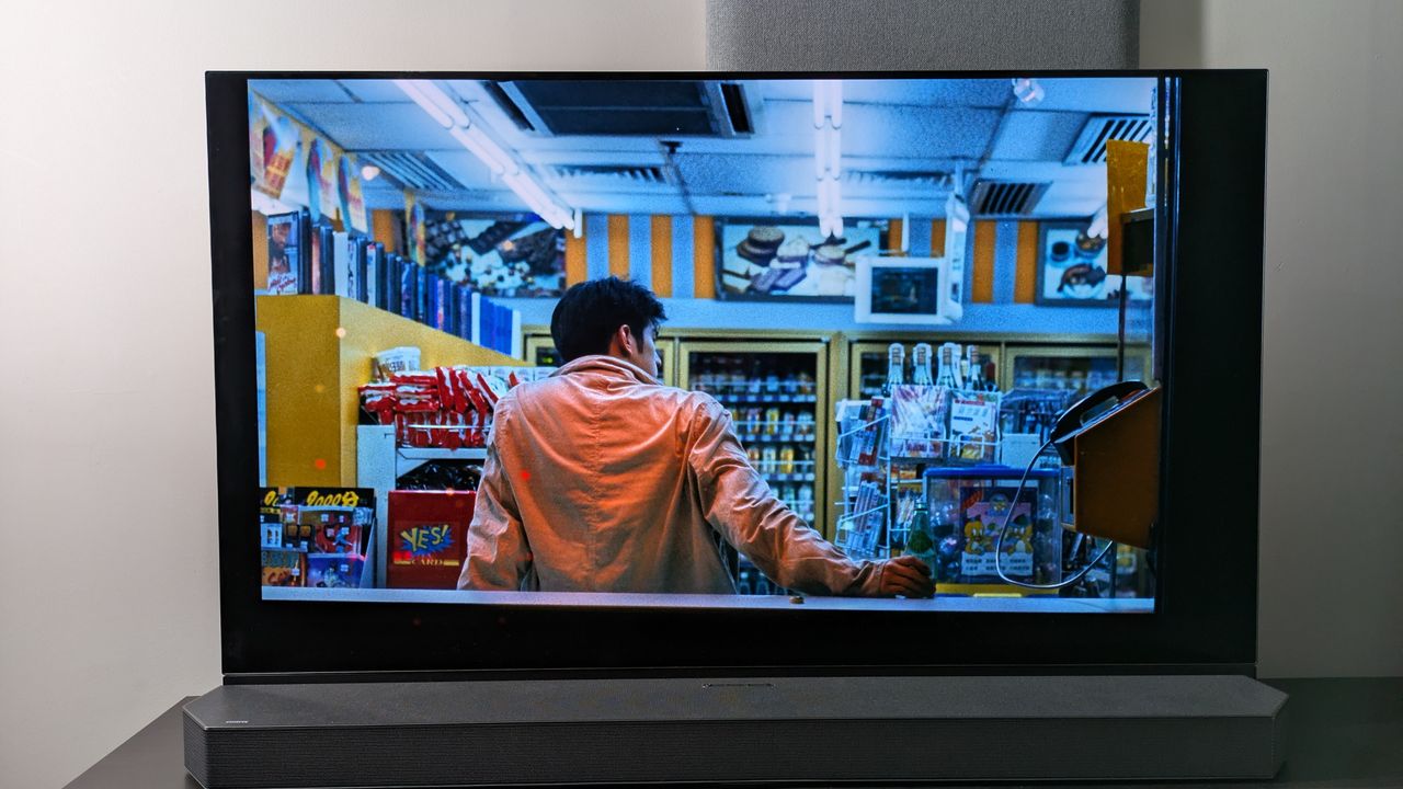 Panasonic OLED showing scene from Chungking Express with man drinking in shop with back turned to camera