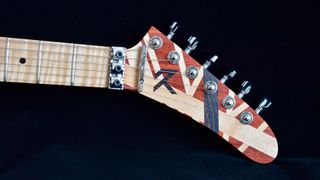 The headstock of an Eddie Van Halen solid wood striped tribute guitar