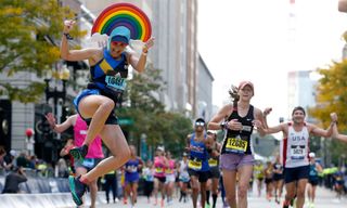 Badia Eskandar leaping over the line of the Boston Marathon