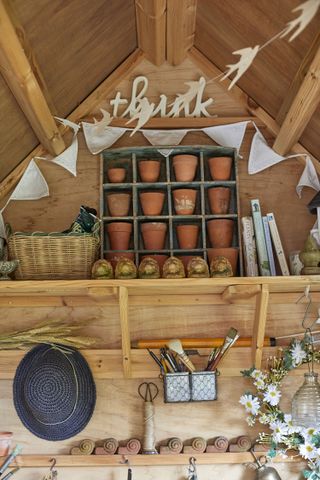 shed ideas: terracotta pots on shelves