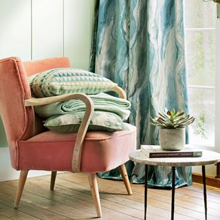 room with wooden flooring and pink chair