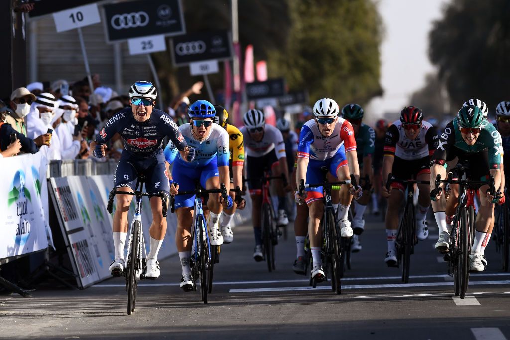 MADINAT ZAYED UNITED ARAB EMIRATES FEBRUARY 20 Jasper Philipsen of Belgium and Team AlpecinFenix celebrates at finish line as stage winner ahead of Dylan Groenewegen of Netherlands and Team Bikeexchange Jaycod Arnaud Demare of France and Team Groupama FDJ and Sam Bennett of Ireland and Team Bora Hansgrohe uring the 4th UAE Tour 2022 Stage 1 a 184km stage from Madinat Zayed to Madinat Zayed UAETour WorldTour on February 20 2022 in Madinat Zayed United Arab Emirates Photo by Tim de WaeleGetty Images