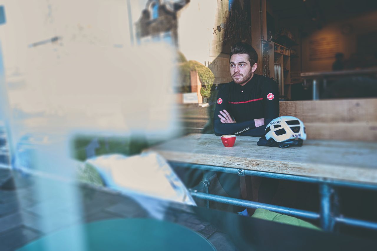 Toby Atkins sits in a coffee shop