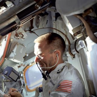 Apollo 7 astronaut Walt Cunningham writes with one of the first Fisher space pens to be used in space in October 1968.