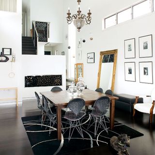 dinning room with white walls and cgandelier