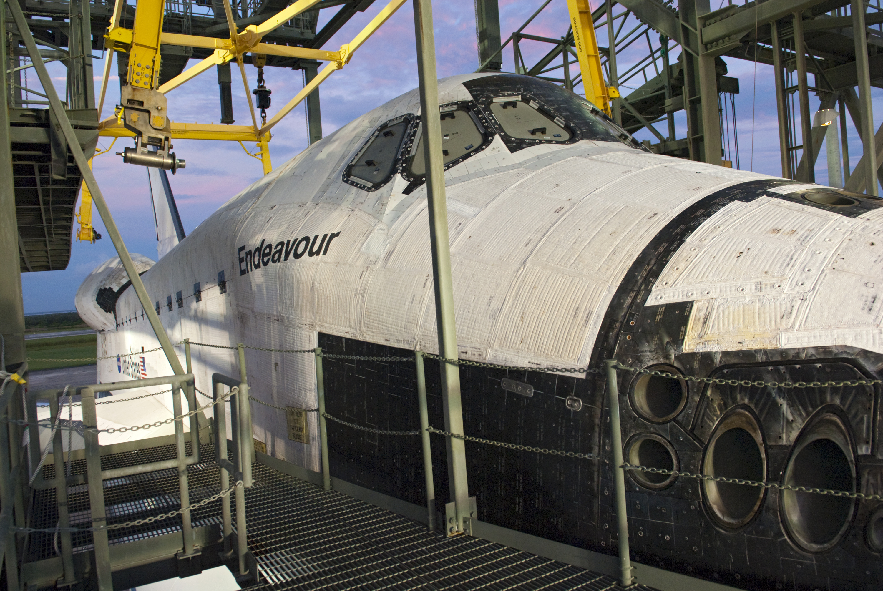 As the sun rises at the Shuttle Landing Facility at NASA's Kennedy Space Center in Florida, space shuttle Endeavour is detached from the mate-demate device after being secured atop NASA's Shuttle Carrier Aircraft, or SCA, for its upcoming ferry flight to