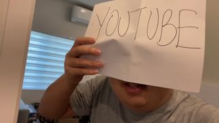 An image of SungWon Cho holding a piece of paper in front of his face reading "YouTube".