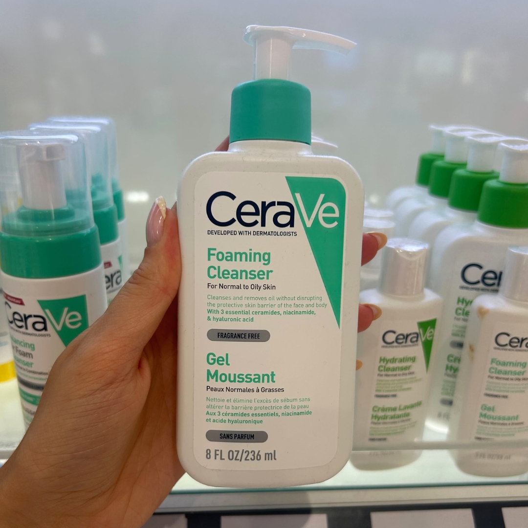 Hand holding bottle of CeraVe Foaming Cleanser in World Duty Free