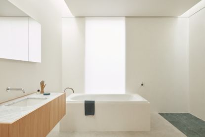 Large tiled bathroom with a bath