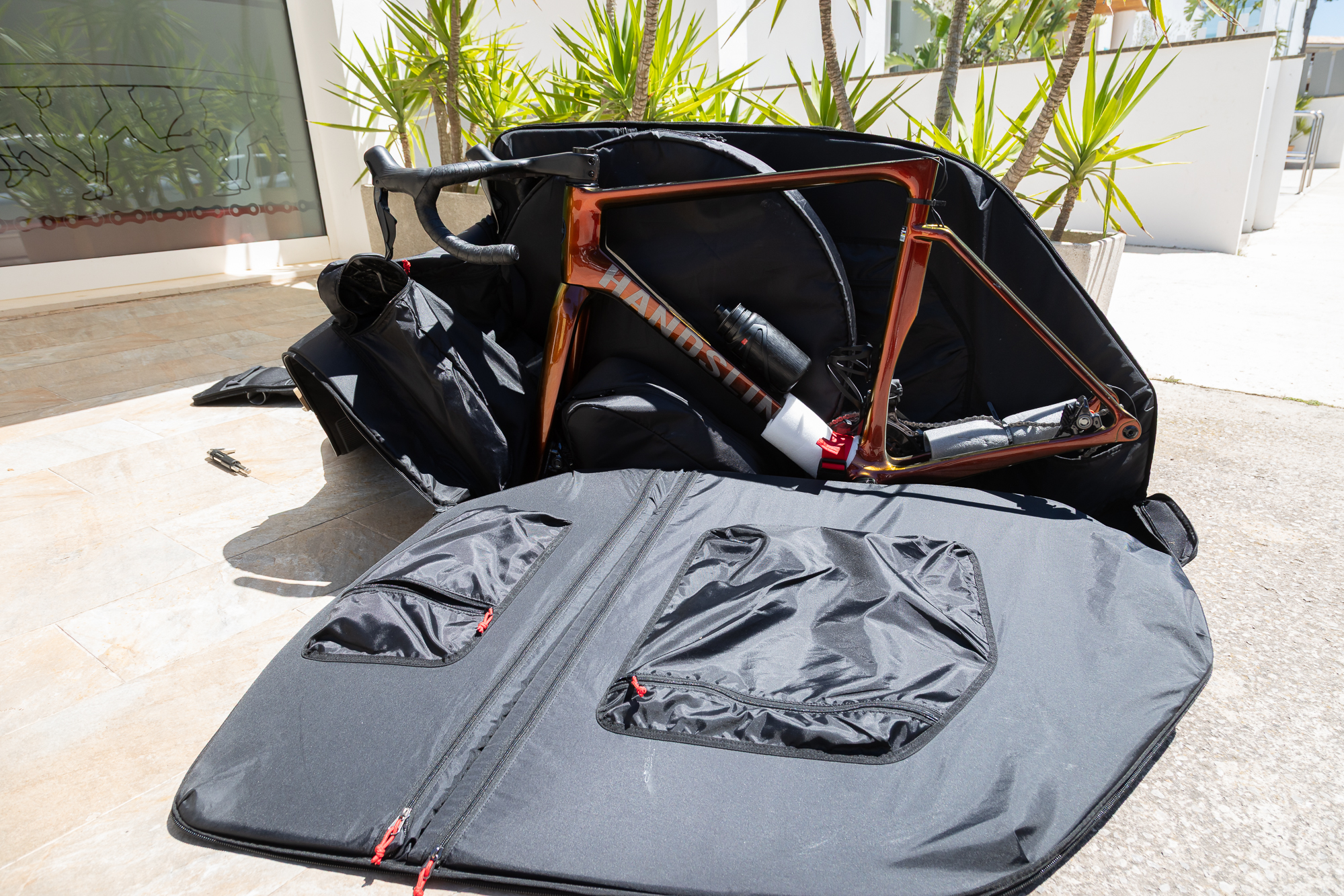 side view of an orange bike packed on a Loomer with one side open