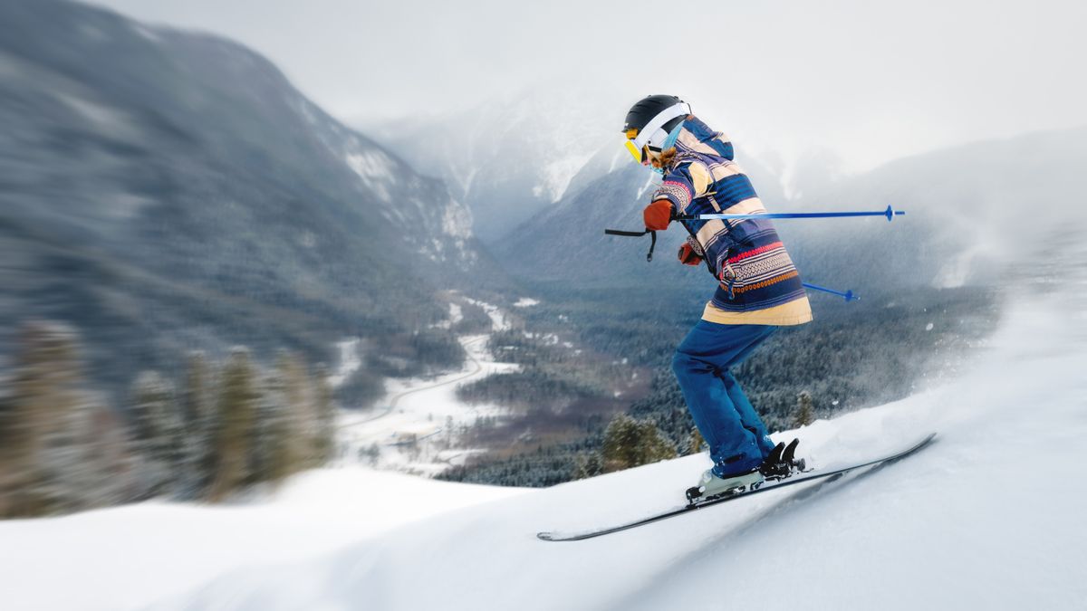 A female athlete skier rides a freeride in a winter forest in the mountains