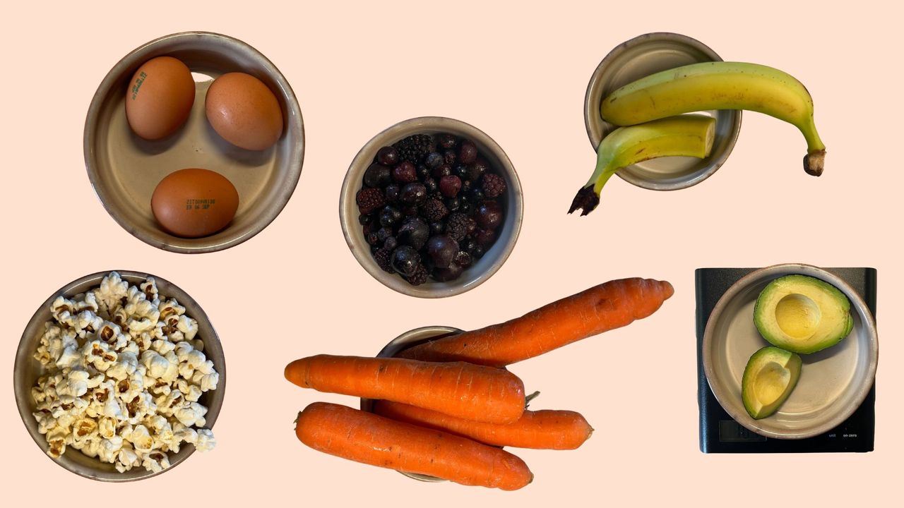 A selection of foods including eggs, berries and strawberries, carrots, and banana worth 200 calories