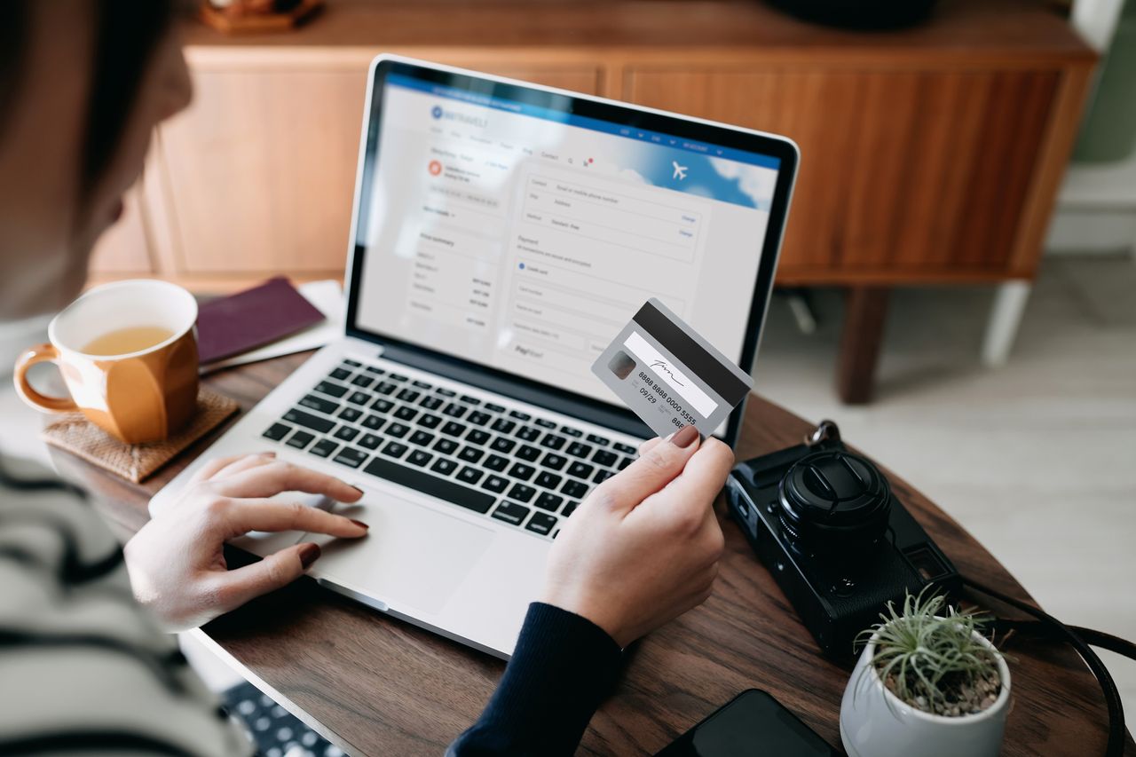 Woman hand with card and laptop