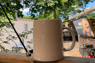A coffee cup pictured on the deck of a Eurocamp holiday home