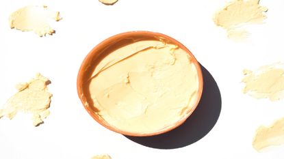 Flat lay of a pot of Shea butter with product swatches