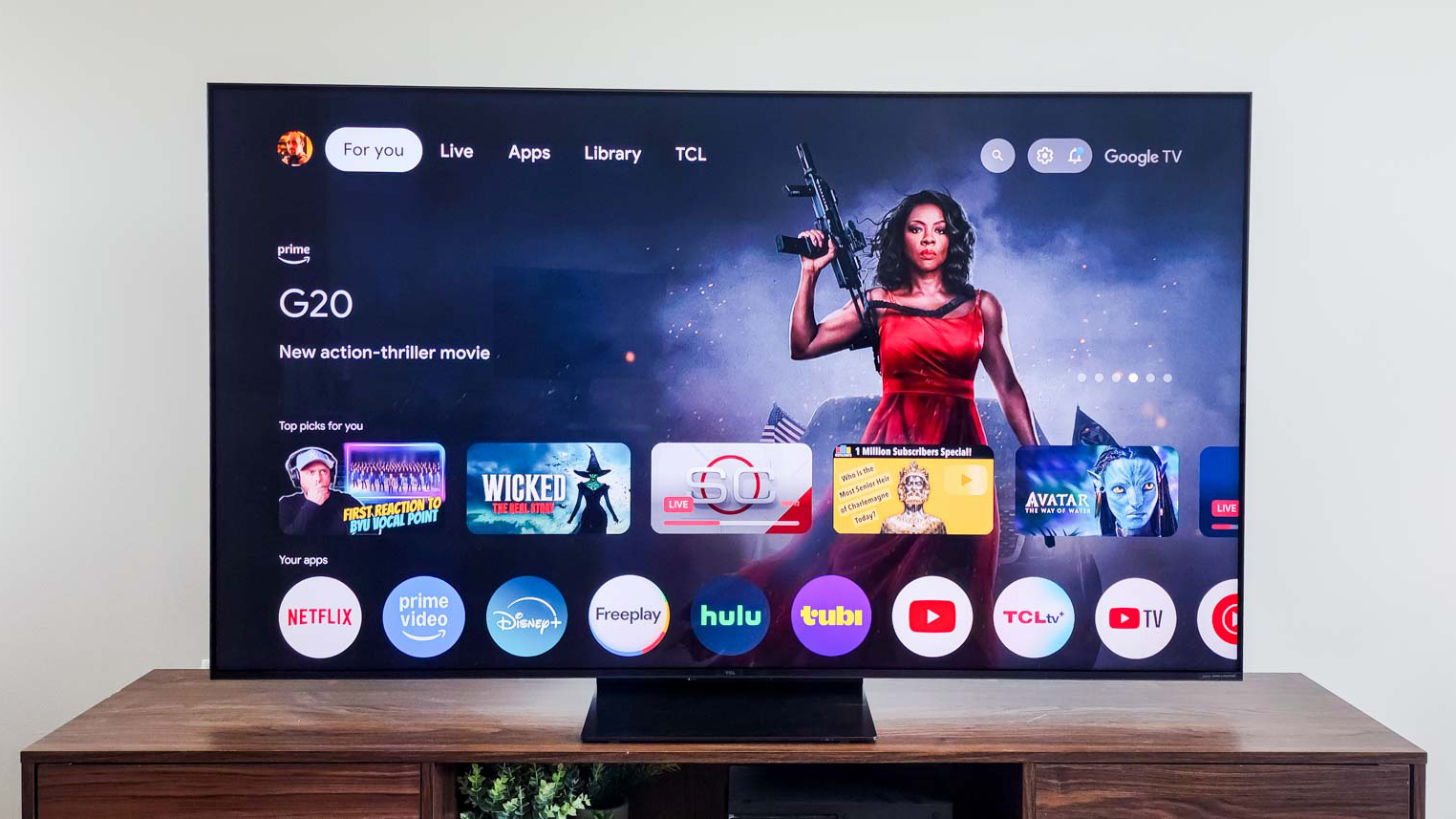 A TCL QM7K QD-Mini LED TV on a side table