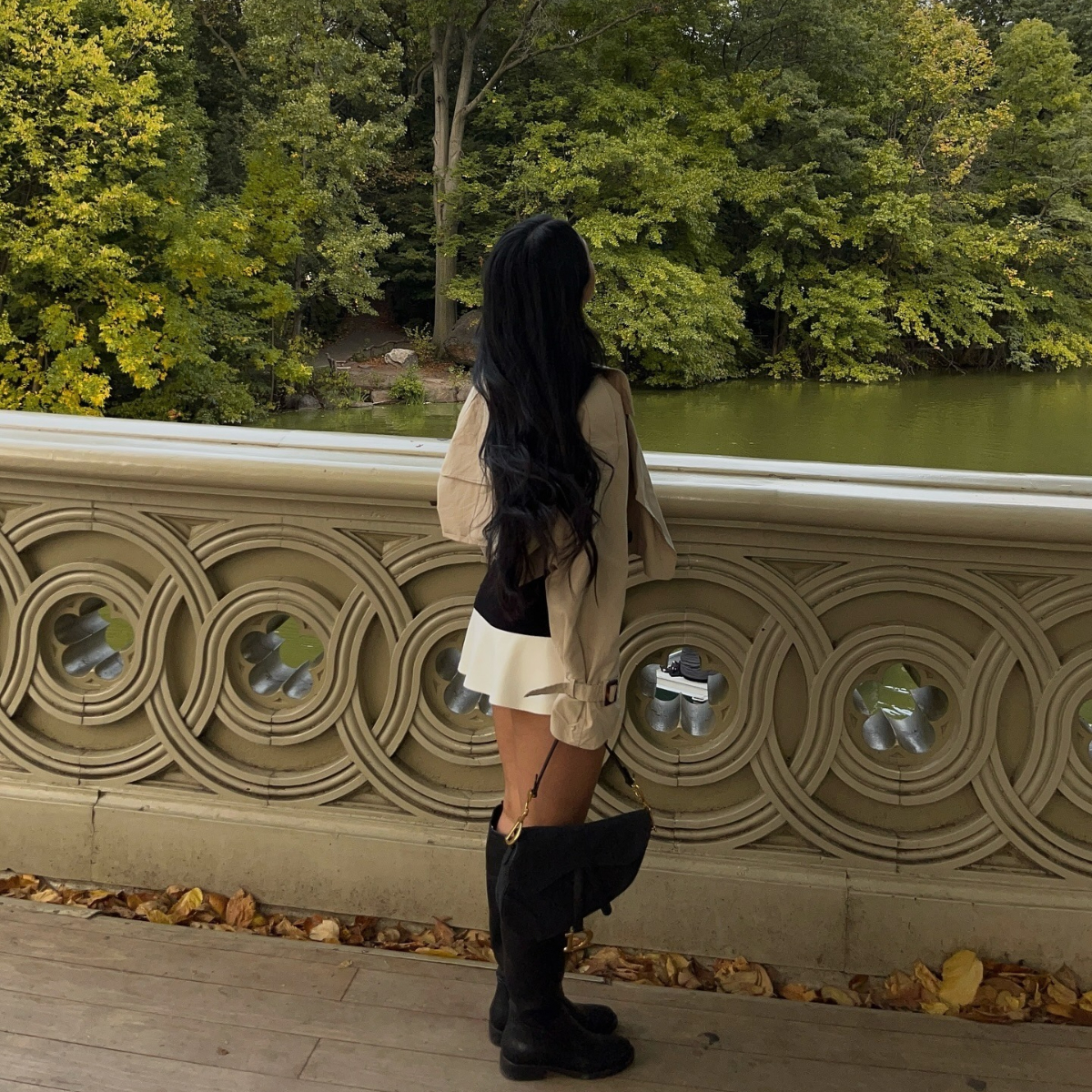 A woman on a bridge in the forest.