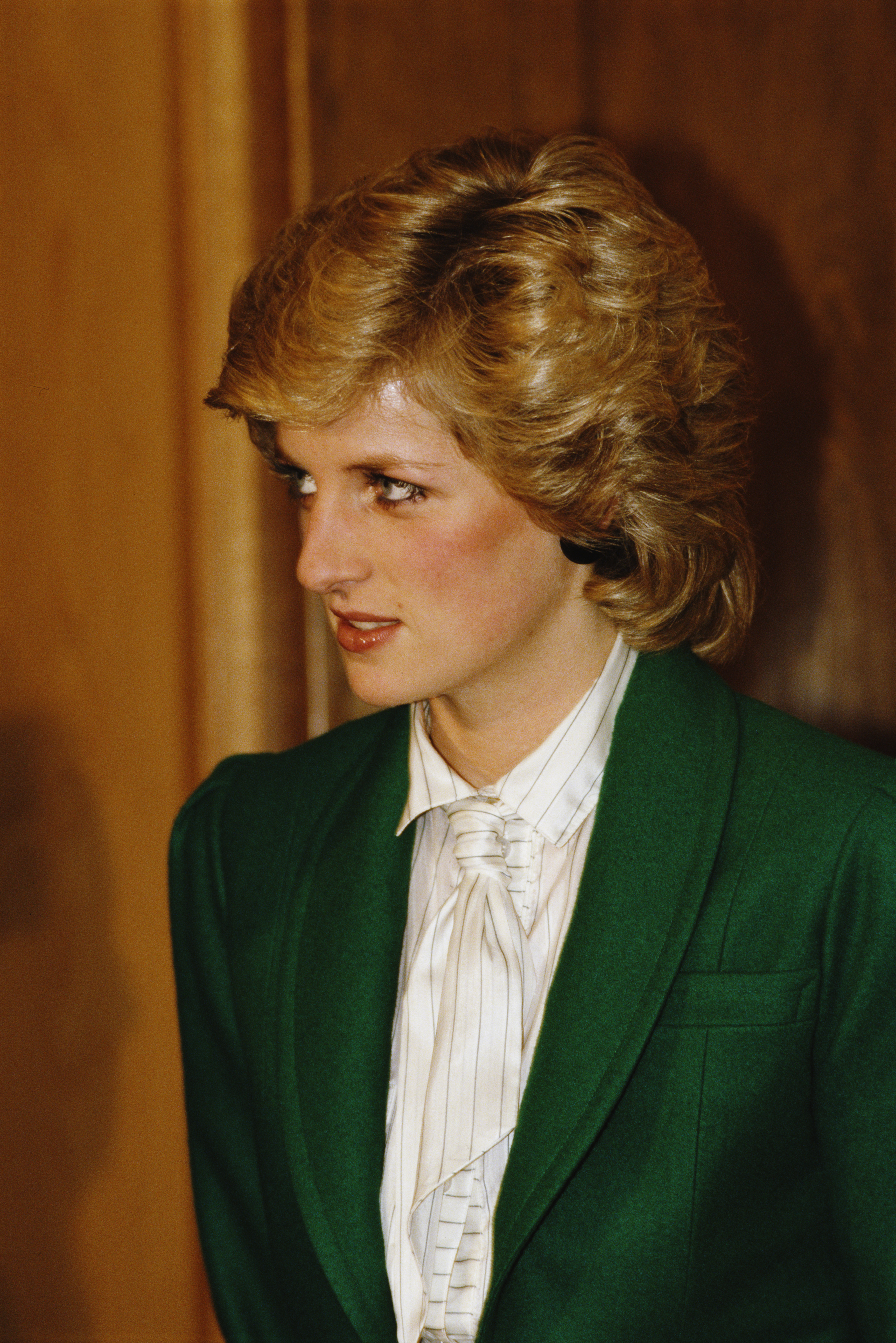 Princess Diana wearing a white tie and green jacket