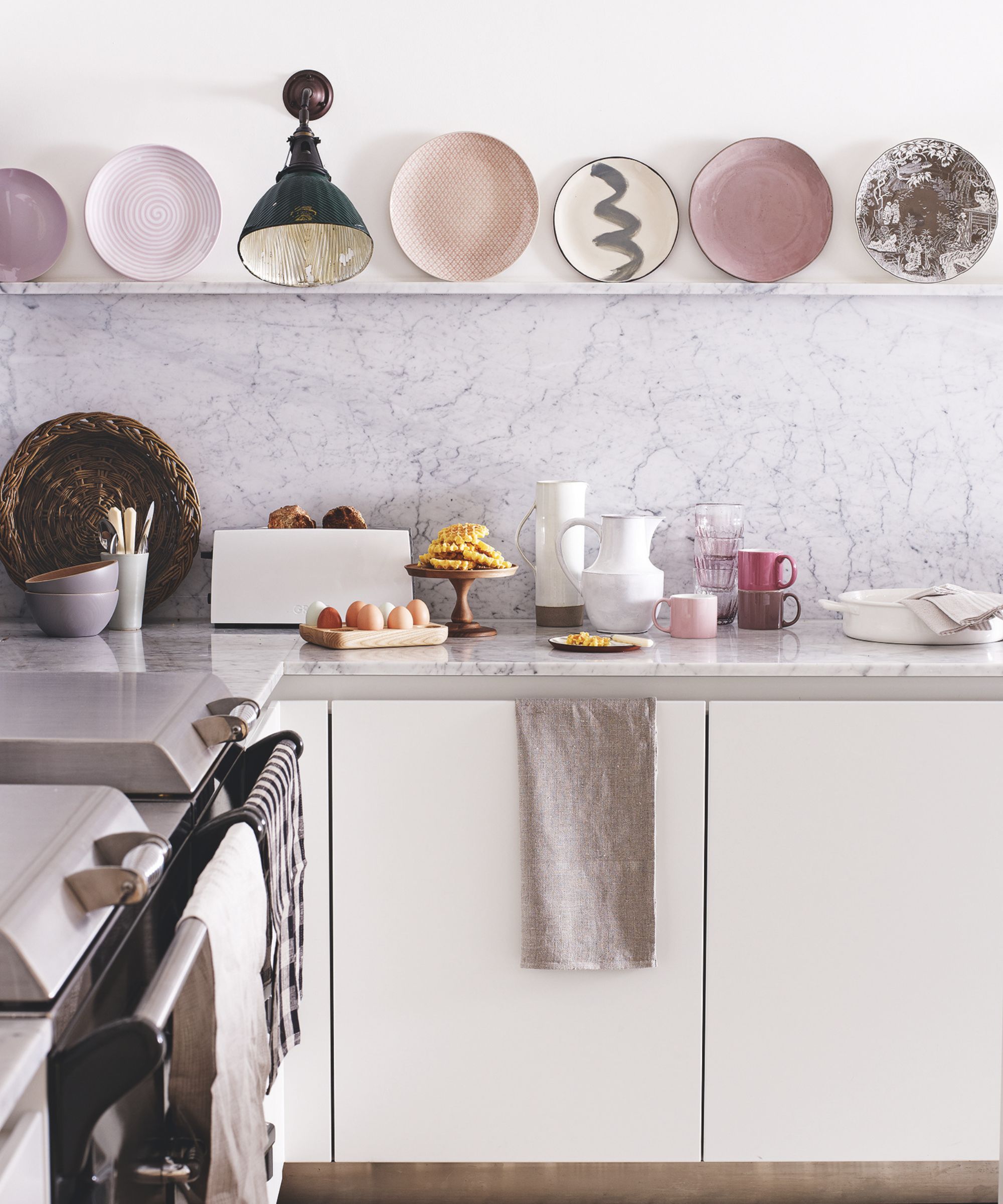 White kitchen with pink plate display