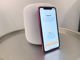 How to use your iPhone, iPad, Apple Watch, or HomePod as an Intercom. Intercom feature displayed on an iPhone 11 in front of a white HomePod.